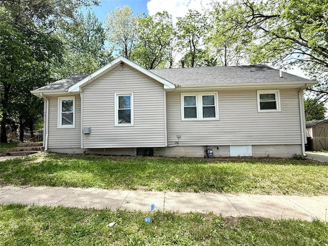 3916 Cambridge St, Des Moines, IA 50313 - rear view of house with a lawn and roof with shingles