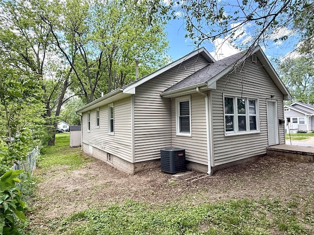 3916 Cambridge St, Des Moines, IA 50313 - view of home's exterior featuring cooling unit and a chimney
