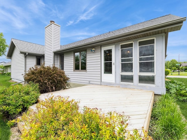 3721 Fletcher Blvd, Ames, IA 50010 - back of house featuring a wooden deck, a chimney, and roof with shingles