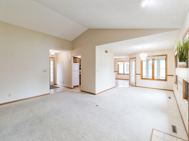 3721 Fletcher Blvd, Ames, IA 50010 - unfurnished living room featuring vaulted ceiling, a chandelier, light carpet, and baseboards
