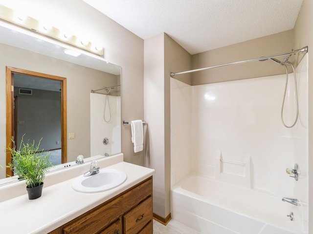 3721 Fletcher Blvd, Ames, IA 50010 - full bath featuring bathing tub / shower combination, vanity, and a textured ceiling