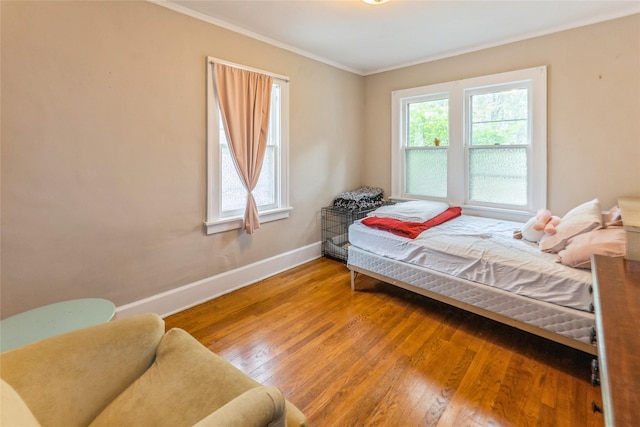 1518 45th St, Des Moines, IA 50311 - bedroom featuring multiple windows, crown molding, wood finished floors, and baseboards