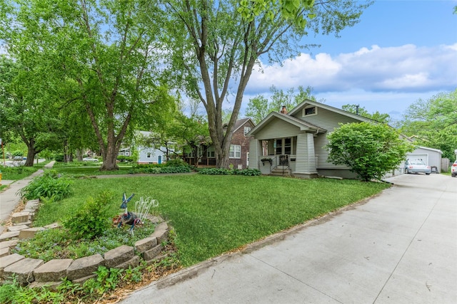 1518 45th St, Des Moines, IA 50311 - view of front facade with a chimney, a front yard, and a detached garage