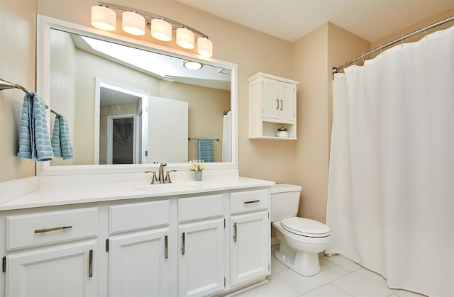 1050 68th St Unit 8, West Des Moines, IA 50266 - bathroom featuring vanity, toilet, tile patterned floors, and curtained shower