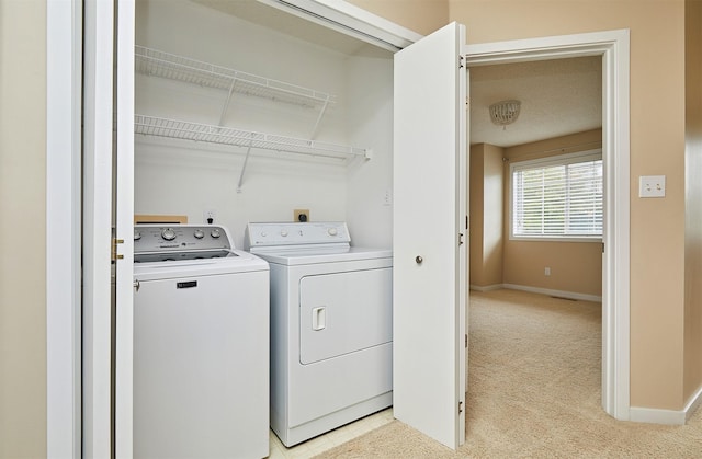 1050 68th St Unit 8, West Des Moines, IA 50266 - laundry room featuring washing machine and dryer, light colored carpet, and baseboards