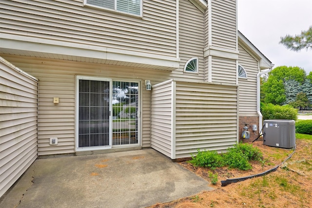 1050 68th St Unit 8, West Des Moines, IA 50266 - entrance to property featuring central air condition unit and a patio area