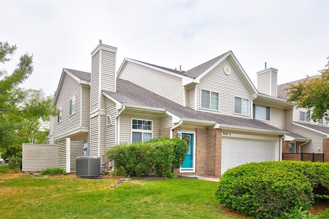 1050 68th St Unit 8, West Des Moines, IA 50266 - view of property featuring a chimney, cooling unit, a garage, and brick siding