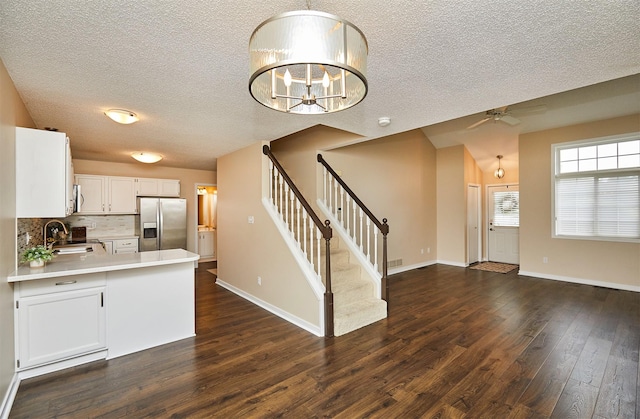 1050 68th St Unit 8, West Des Moines, IA 50266 - kitchen featuring stainless steel appliances, a ceiling fan, dark wood-style floors, a textured ceiling, and light countertops