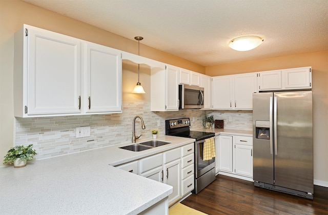 1050 68th St Unit 8, West Des Moines, IA 50266 - kitchen featuring appliances with stainless steel finishes, a sink, white cabinetry, light countertops, and a textured ceiling