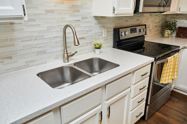 1050 68th St Unit 8, West Des Moines, IA 50266 - kitchen with appliances with stainless steel finishes, a sink, tasteful backsplash, and white cabinets
