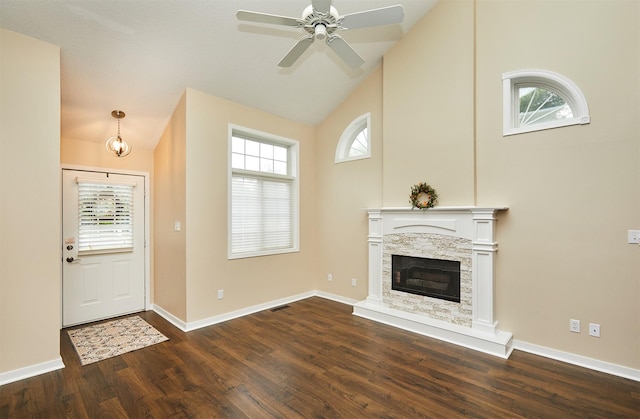 1050 68th St Unit 8, West Des Moines, IA 50266 - unfurnished living room with dark wood-type flooring, plenty of natural light, high vaulted ceiling, and a stone fireplace