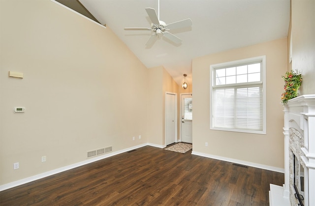 1050 68th St Unit 8, West Des Moines, IA 50266 - unfurnished living room with a fireplace with raised hearth, ceiling fan, dark wood-style floors, baseboards, and high vaulted ceiling