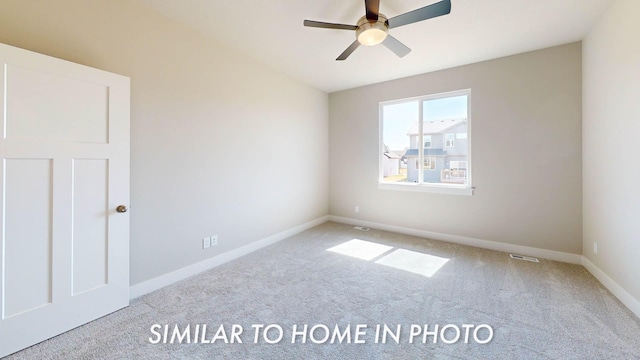 2540 E 50th Ct, Des Moines, IA 50317 - carpeted spare room with ceiling fan and baseboards