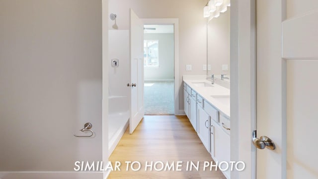 2540 E 50th Ct, Des Moines, IA 50317 - bathroom with double vanity and wood finished floors