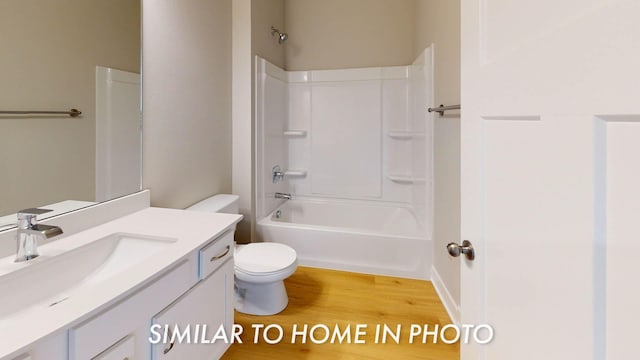 2540 E 50th Ct, Des Moines, IA 50317 - full bath with wood finished floors, vanity, toilet, and tub / shower combination