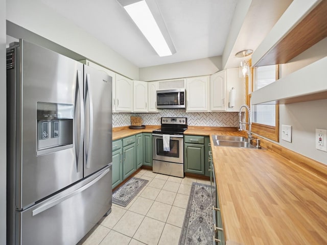 5180 NW 64th Pl, Johnston, IA 50131 - kitchen with stainless steel appliances, butcher block countertops, a sink, and white cabinetry