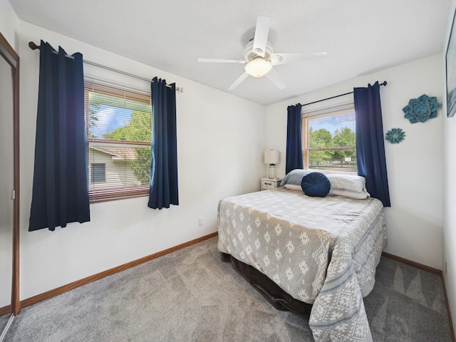 5180 NW 64th Pl, Johnston, IA 50131 - bedroom featuring carpet flooring, baseboards, and a ceiling fan