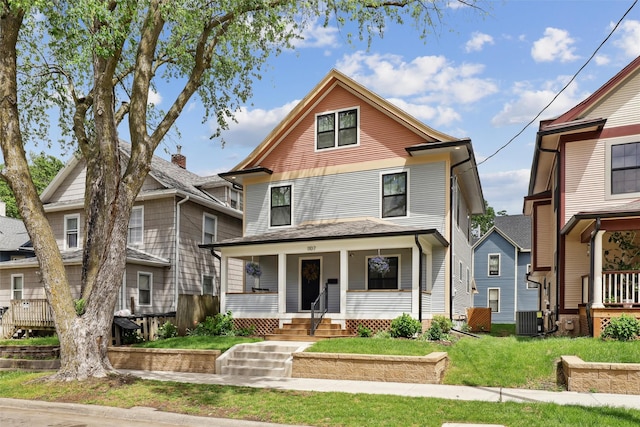 1107 24th St, Des Moines, IA 50311 - traditional style home featuring a porch, central AC, and a front lawn