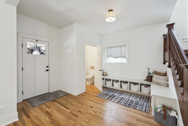 1107 24th St, Des Moines, IA 50311 - foyer entrance featuring plenty of natural light, wood finished floors, stairway, and baseboards