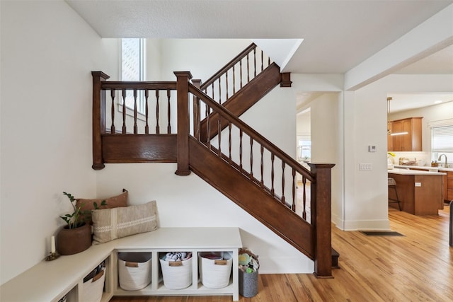 1107 24th St, Des Moines, IA 50311 - staircase featuring wood finished floors and baseboards