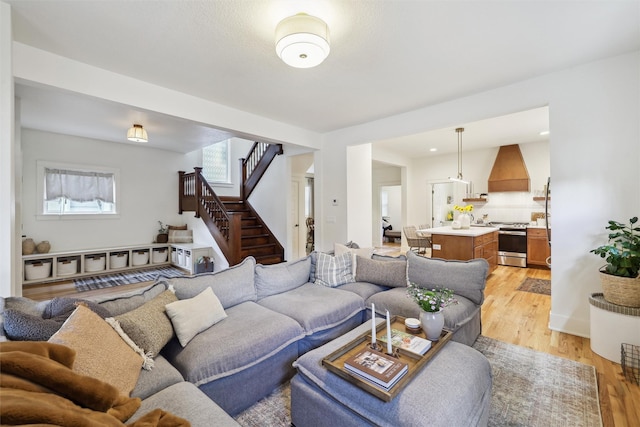 1107 24th St, Des Moines, IA 50311 - living room with light wood-type flooring and stairs