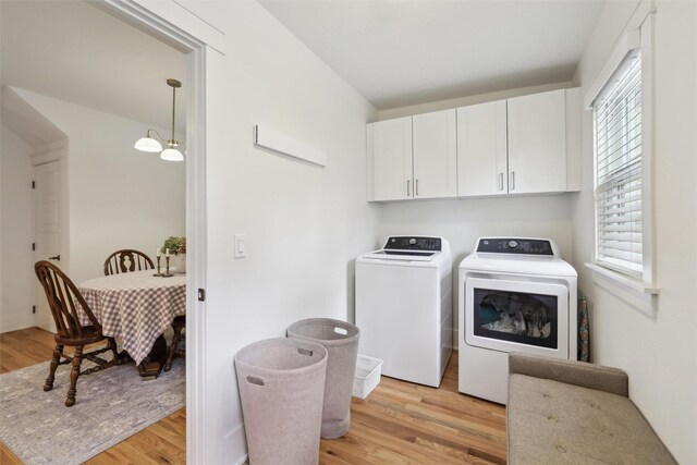 1107 24th St, Des Moines, IA 50311 - laundry room with cabinet space, washer and dryer, and light wood-type flooring