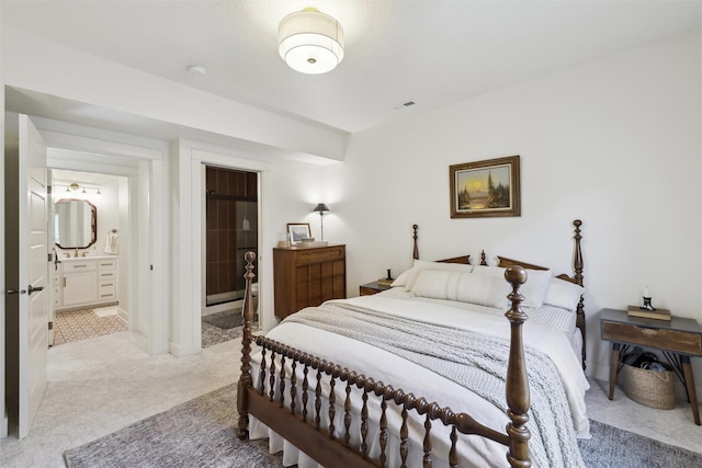 1107 24th St, Des Moines, IA 50311 - bedroom with light colored carpet and ensuite bathroom