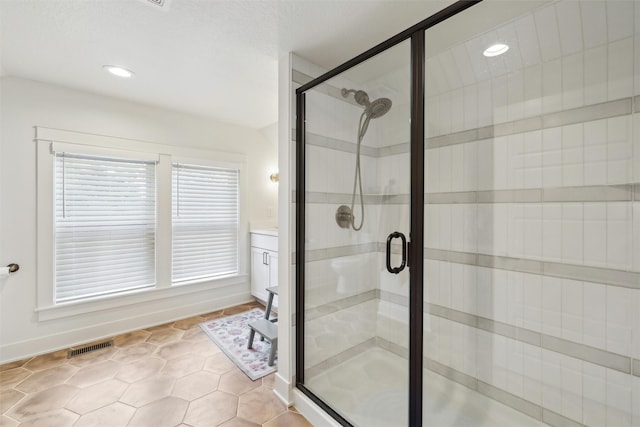 1107 24th St, Des Moines, IA 50311 - bathroom with a stall shower, baseboards, vanity, tile patterned floors, and recessed lighting