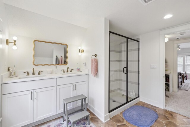 1107 24th St, Des Moines, IA 50311 - bathroom featuring double vanity, a stall shower, recessed lighting, and baseboards