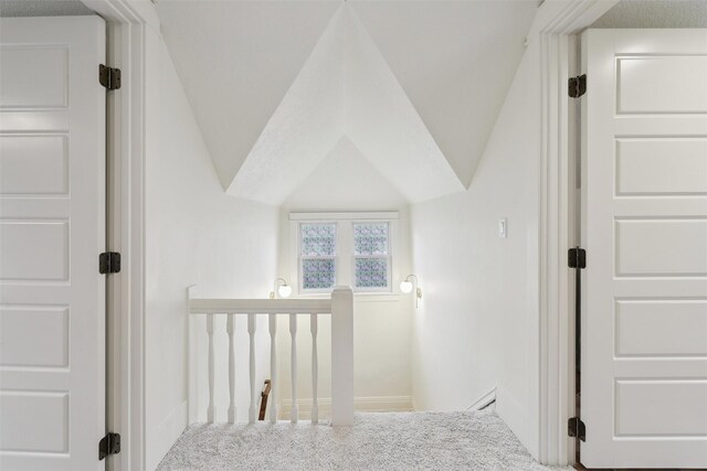 1107 24th St, Des Moines, IA 50311 - staircase featuring carpet floors, vaulted ceiling, and baseboards