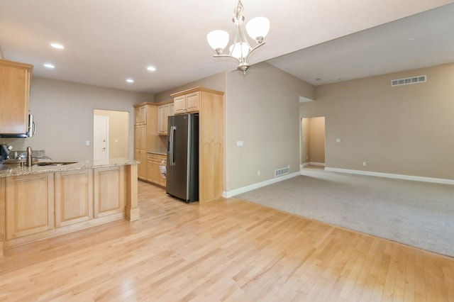 1960 NW 126th St, Clive, IA 50325 - kitchen featuring stainless steel refrigerator with ice dispenser, light brown cabinets, light wood-style flooring, baseboards, and recessed lighting
