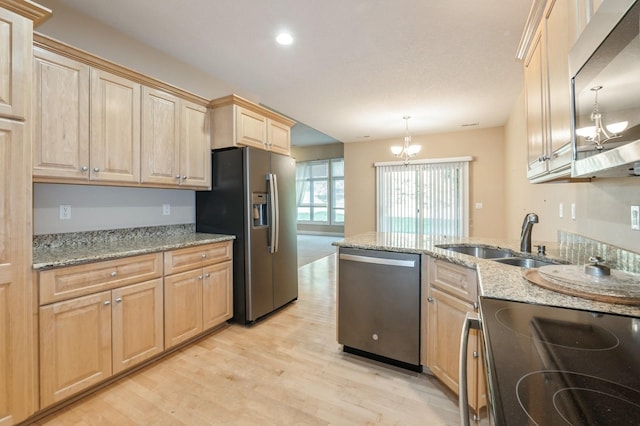 1960 NW 126th St, Clive, IA 50325 - kitchen with stainless steel appliances, light brown cabinetry, a chandelier, a sink, and light wood-style flooring