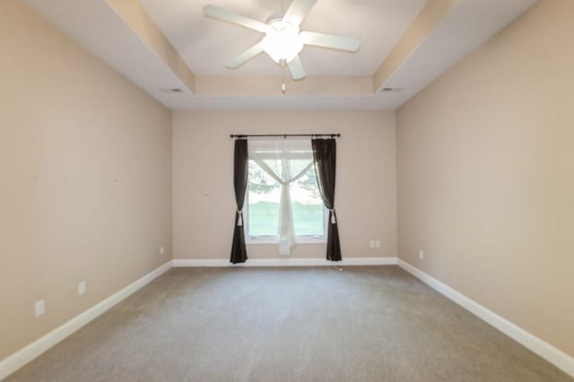 1960 NW 126th St, Clive, IA 50325 - carpeted spare room featuring a tray ceiling, baseboards, and ceiling fan