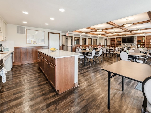 1250 SW Magazine Rd Unit 105, Ankeny, IA 50023 - kitchen with light countertops, recessed lighting, dark wood-style flooring, coffered ceiling, and a kitchen island