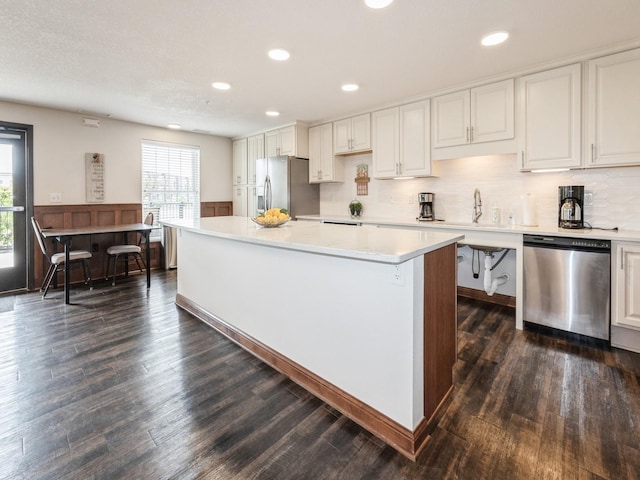 1250 SW Magazine Rd Unit 105, Ankeny, IA 50023 - kitchen with stainless steel appliances, light countertops, a kitchen island, white cabinetry, and recessed lighting