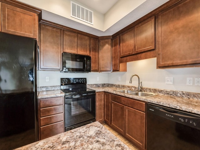 1250 SW Magazine Rd Unit 105, Ankeny, IA 50023 - kitchen with black appliances, a sink, and light stone counters