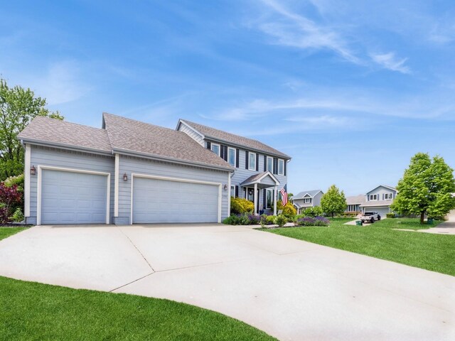 2190 NW 147th St, Clive, IA 50325 - colonial home featuring a garage, concrete driveway, and a front lawn