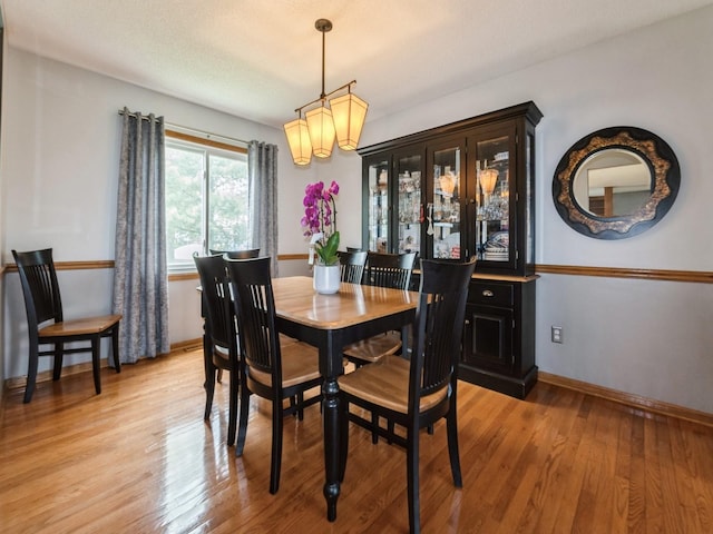 2190 NW 147th St, Clive, IA 50325 - dining area with light wood-style floors, baseboards, and a chandelier