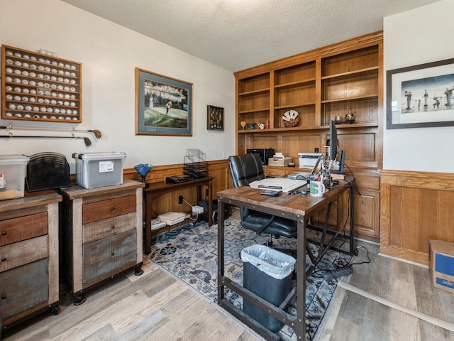 2190 NW 147th St, Clive, IA 50325 - home office featuring a textured ceiling, light wood-style floors, and wainscoting