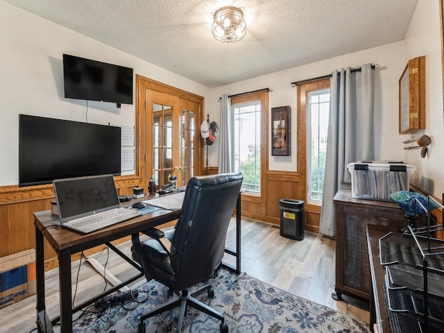 2190 NW 147th St, Clive, IA 50325 - home office with light wood-style floors, a textured ceiling, and wainscoting
