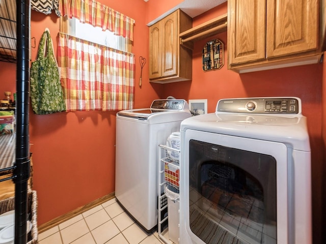 2190 NW 147th St, Clive, IA 50325 - laundry area featuring cabinet space, independent washer and dryer, and light tile patterned floors