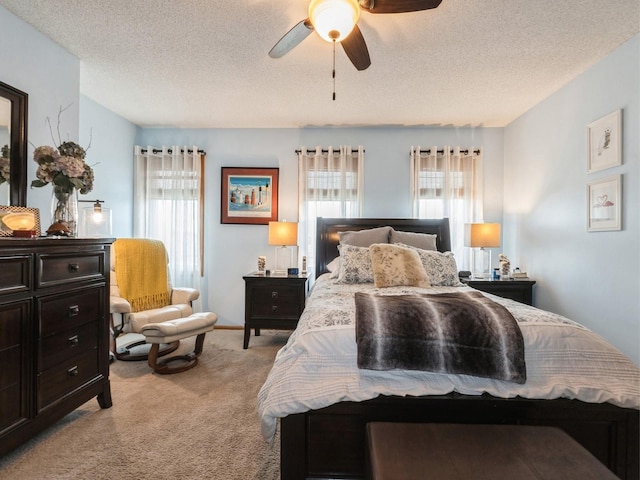 2190 NW 147th St, Clive, IA 50325 - bedroom with light colored carpet, a textured ceiling, and ceiling fan