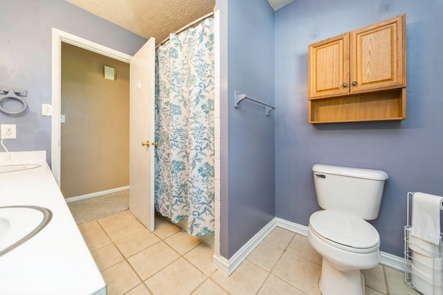 1223 Cherry Pkwy, Norwalk, IA 50211 - full bath with tile patterned flooring, double vanity, toilet, baseboards, and a textured ceiling