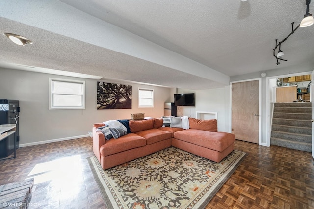 1223 Cherry Pkwy, Norwalk, IA 50211 - living area featuring baseboards, a textured ceiling, and stairway