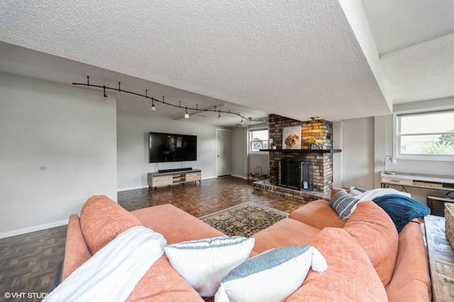 1223 Cherry Pkwy, Norwalk, IA 50211 - living room with baseboards, a textured ceiling, and a fireplace