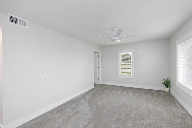 205 NW 51st Pl, Des Moines, IA 50313 - empty room with healthy amount of natural light, carpet, and baseboards