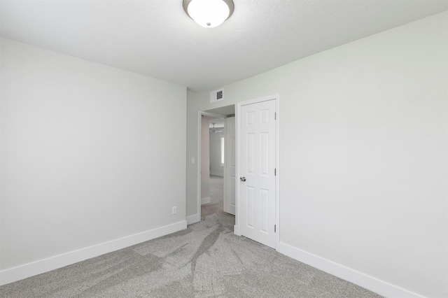 205 NW 51st Pl, Des Moines, IA 50313 - spare room with baseboards and carpet flooring