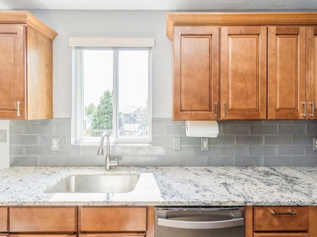 900 SE Woodbine Dr, Grimes, IA 50111 - kitchen featuring stainless steel dishwasher, a sink, backsplash, and light stone countertops