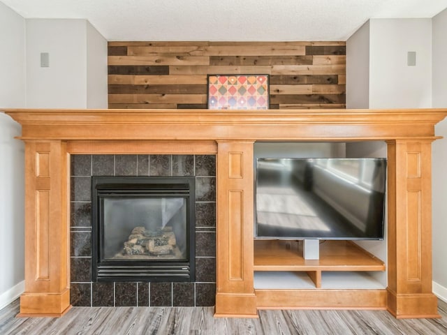 900 SE Woodbine Dr, Grimes, IA 50111 - detailed view of wood finished floors, baseboards, and a fireplace