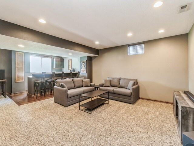 900 SE Woodbine Dr, Grimes, IA 50111 - carpeted living area with recessed lighting, baseboards, and bar area
